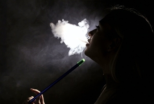 Girl smokes a hookah