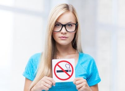 Girl holding a no smoking sign at the entrance